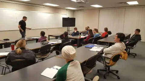 Students taking notes during a classroom presentation