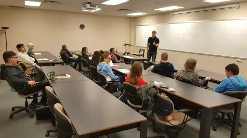 Speaker delivering a lecture to bootcamp participants