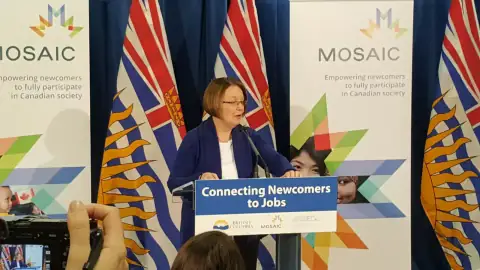 Participants listening to a speaker in a daytime workshop room