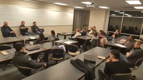 Participants collaborating in a classroom with an instructor