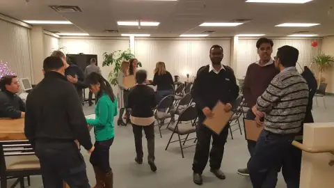 Attendees networking and congratulating each other after a program