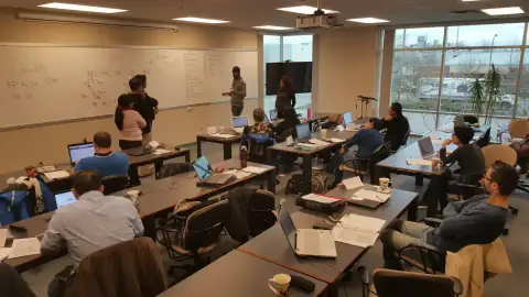 Class interacting with an instructor during a whiteboard exercise