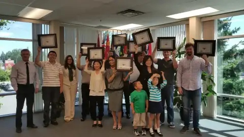 Group of START Canada graduates holding certificates and cheering