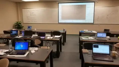 Instructor pointing at a projected diagram during class