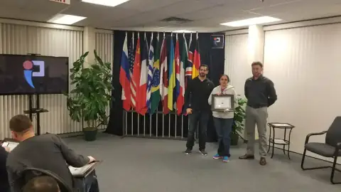 Graduate receiving certificate from START Canada instructor