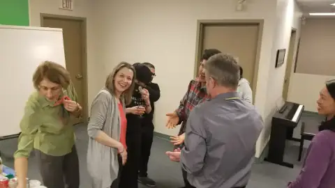 Group celebrating with certificates and conversations