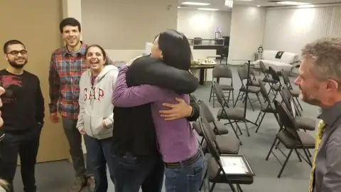 Group of graduates hugging and celebrating together