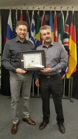 Two START Canada leaders holding a certificate of completion