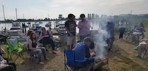 Community members relaxing and grilling together outdoors