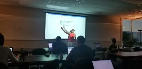 Instructor presenting code on a projector to bootcamp students